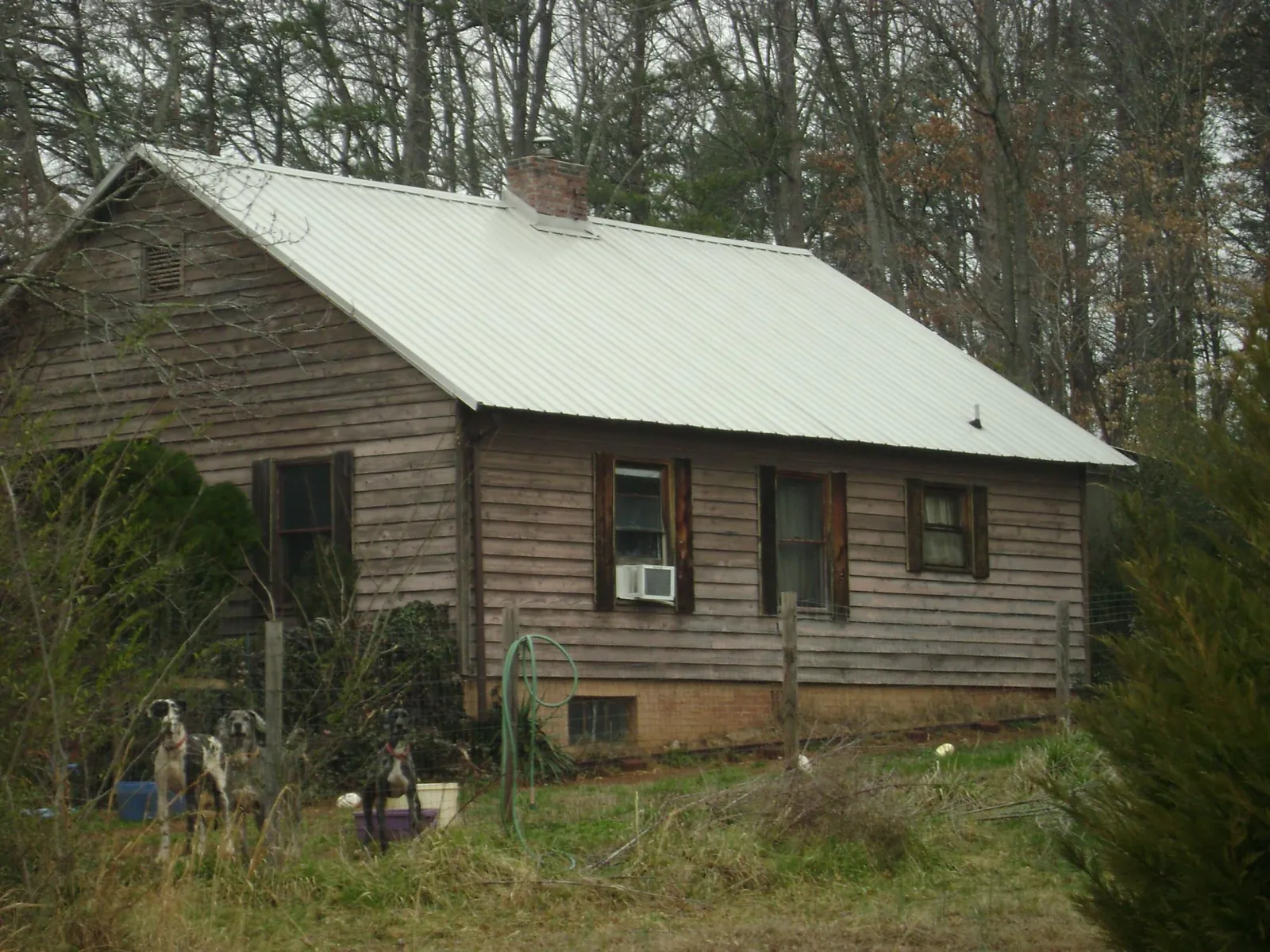 White metal roof on an old wood sided farmhouse, from a Metal Roof Installation job in Newark
